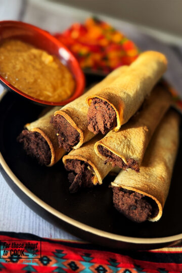 Refried bean taquitos served with chipotle dip
