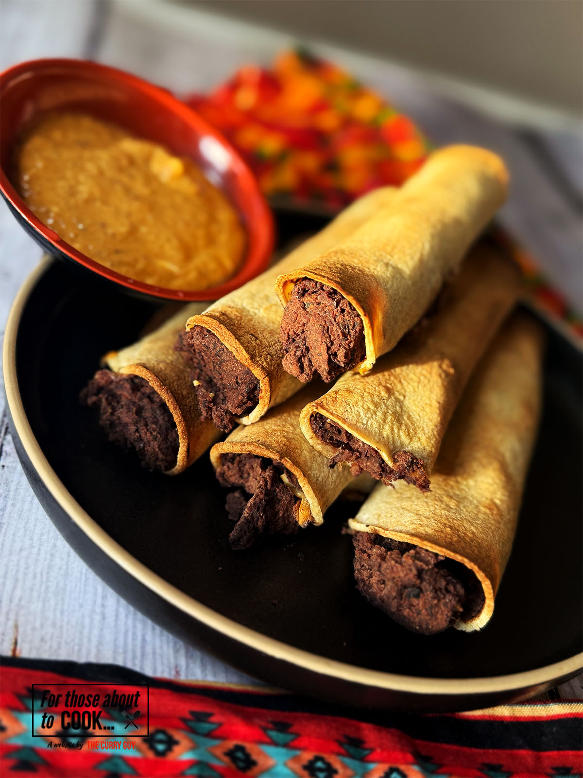 Refried bean taquitos served with chipotle dip