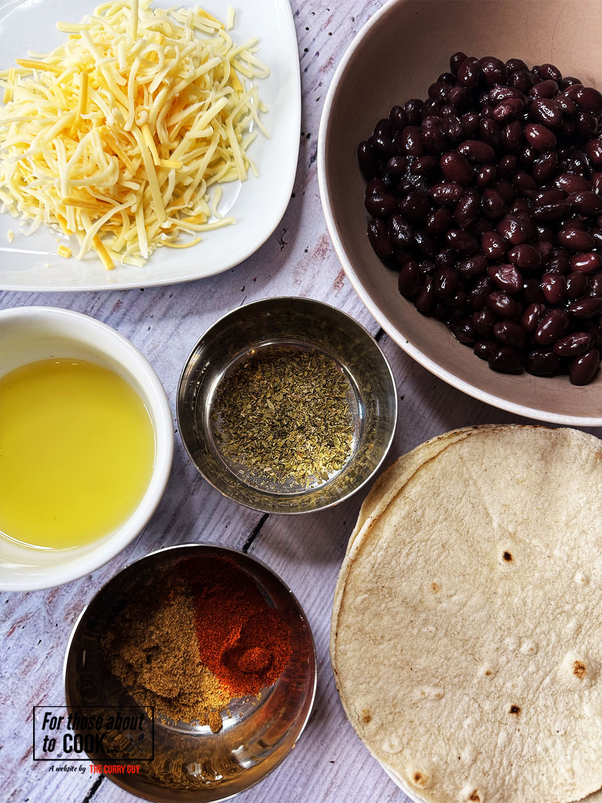 Ingredients for bean taquitos separated into bowls