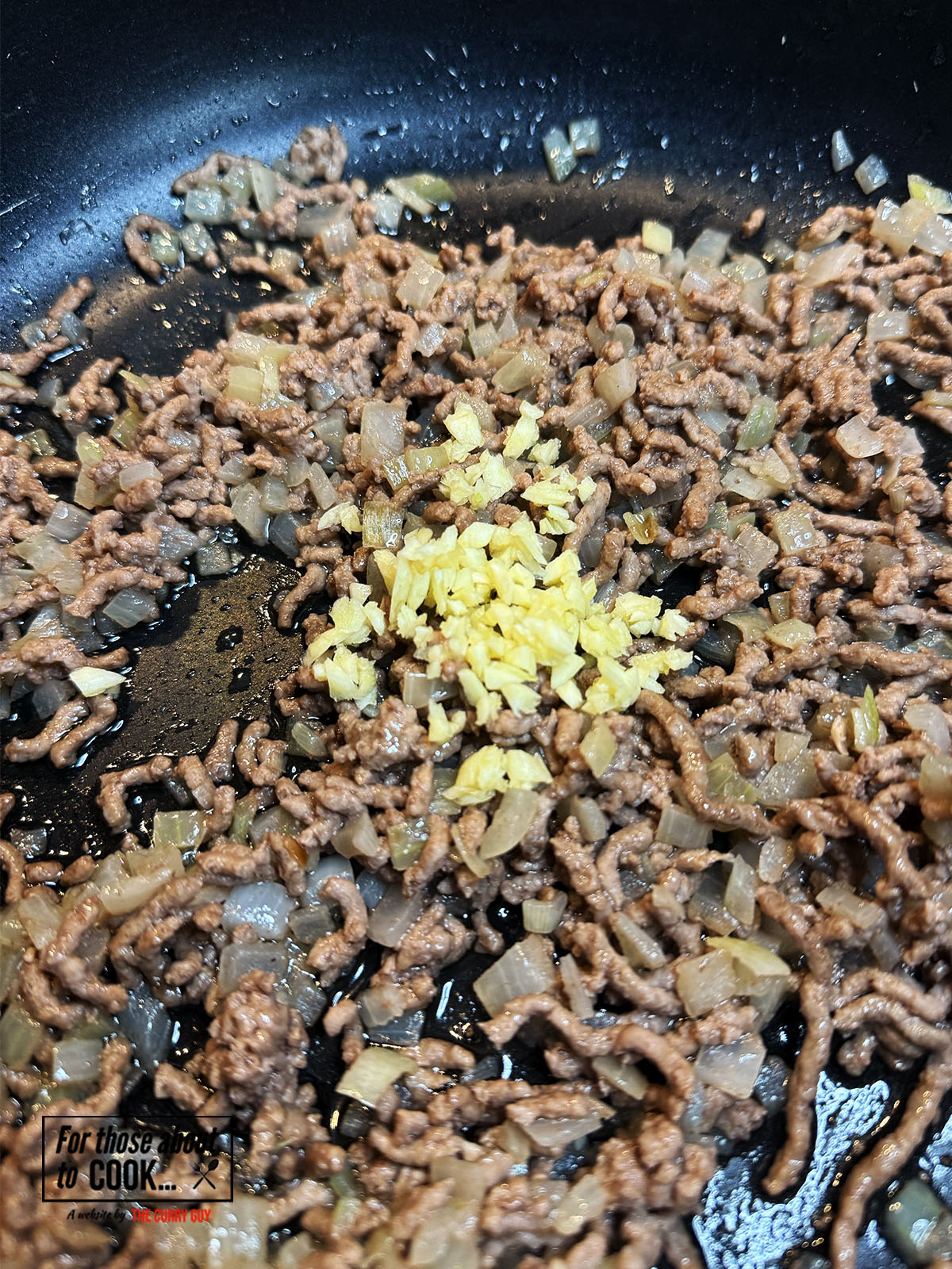 Minced garlic added to the pan and fried for a minute