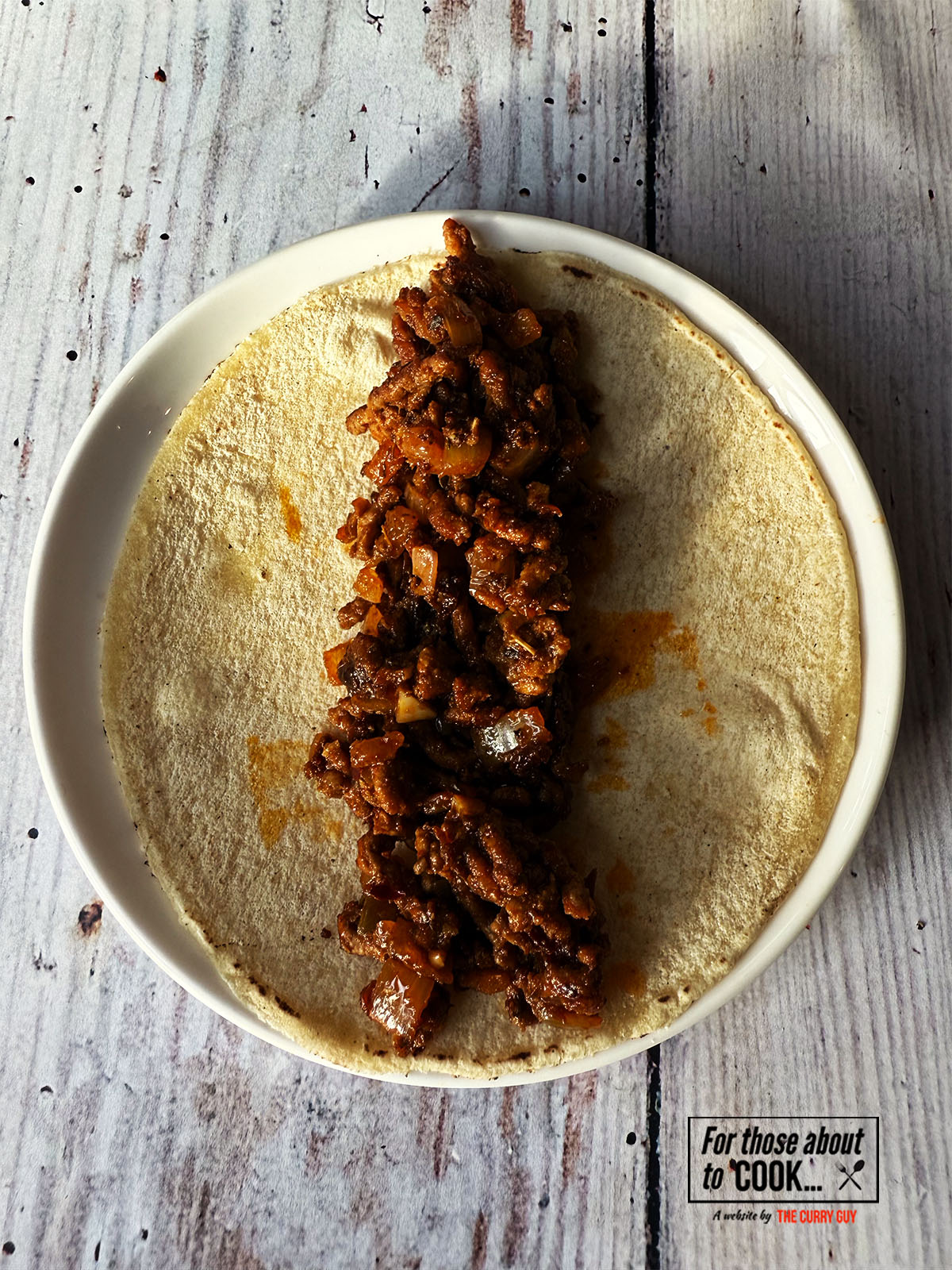 Spicy beef taquitos filling added to the tortilla