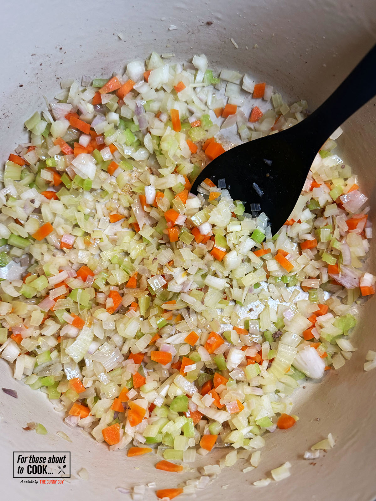 Celery, carrot, onion and shallots sauteing in a pan