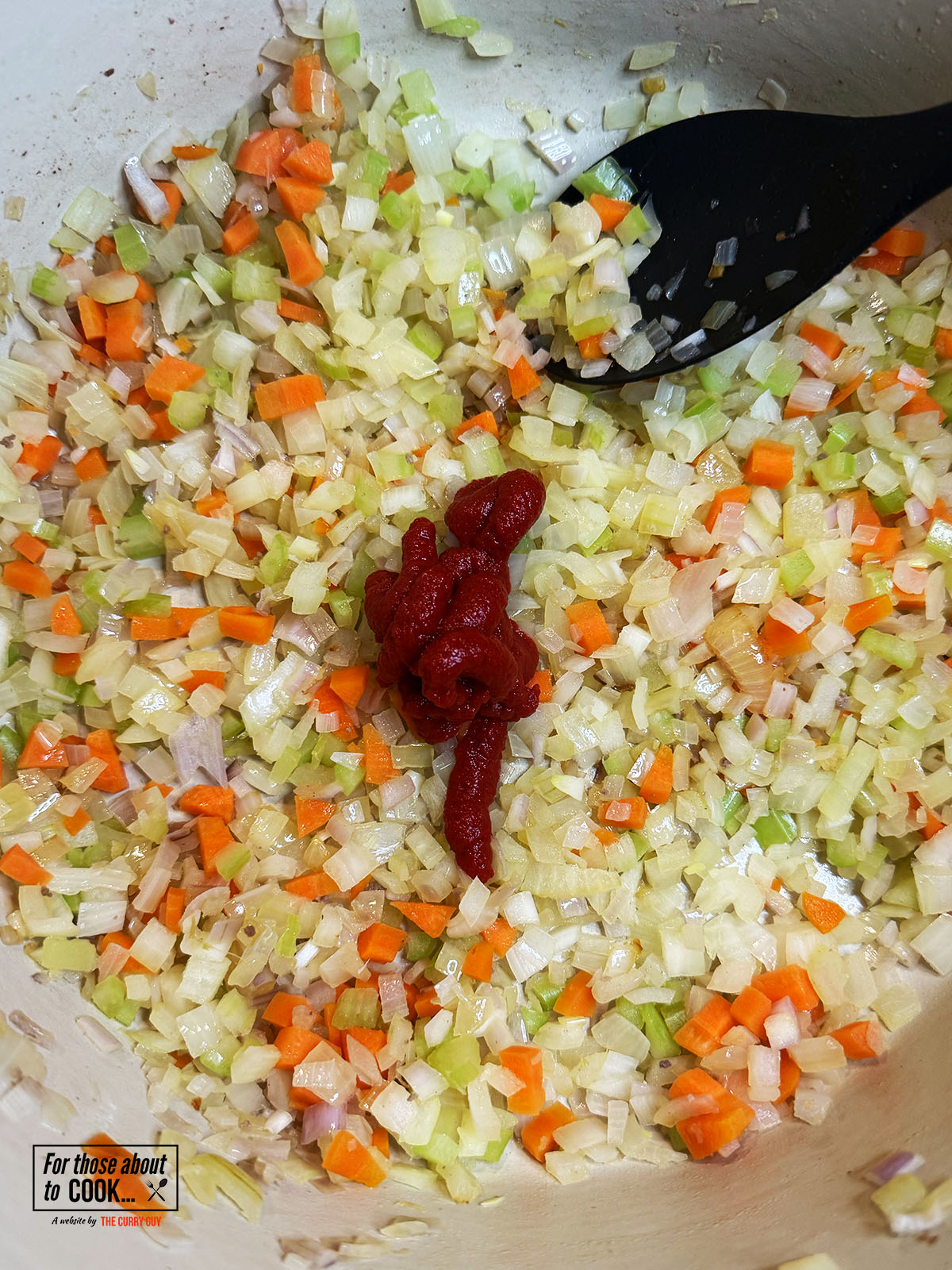 Tomato puree added to the pan