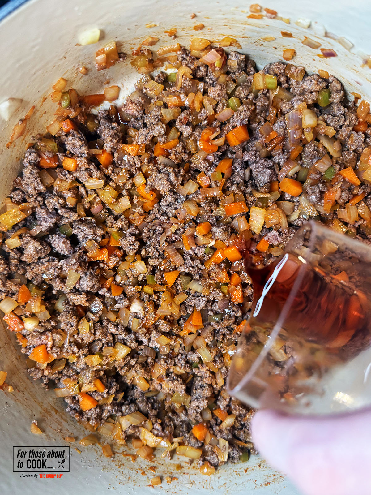 Browned beef and red wine added to the pan