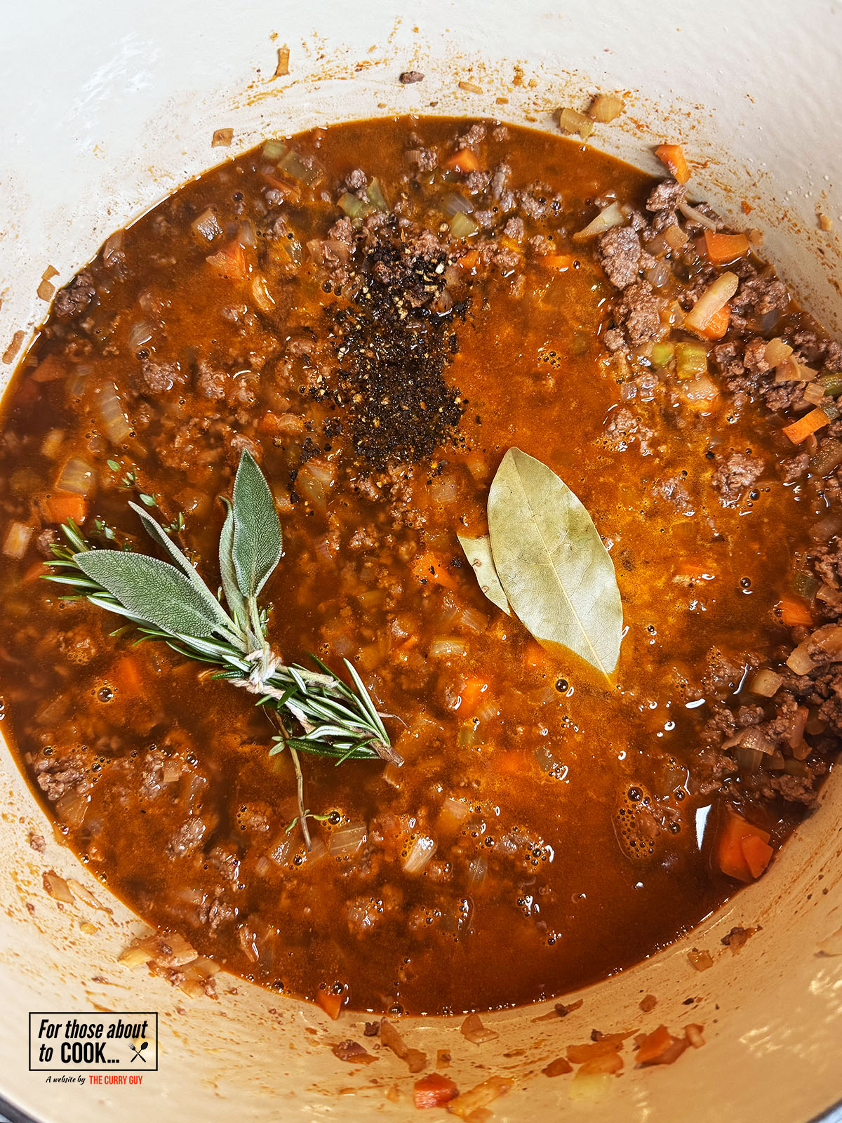 Beef stock, fresh herbs and bay leaves added to the pot to simmer
