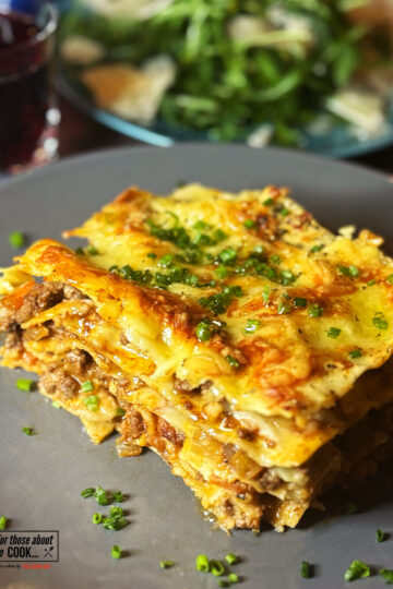 Lasagne served on a plate with rocket salad