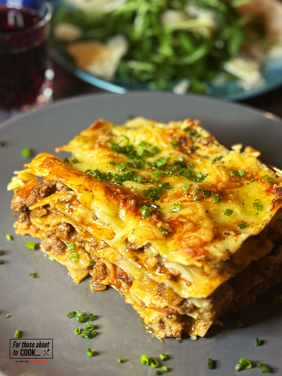 Lasagne served on a plate with rocket salad