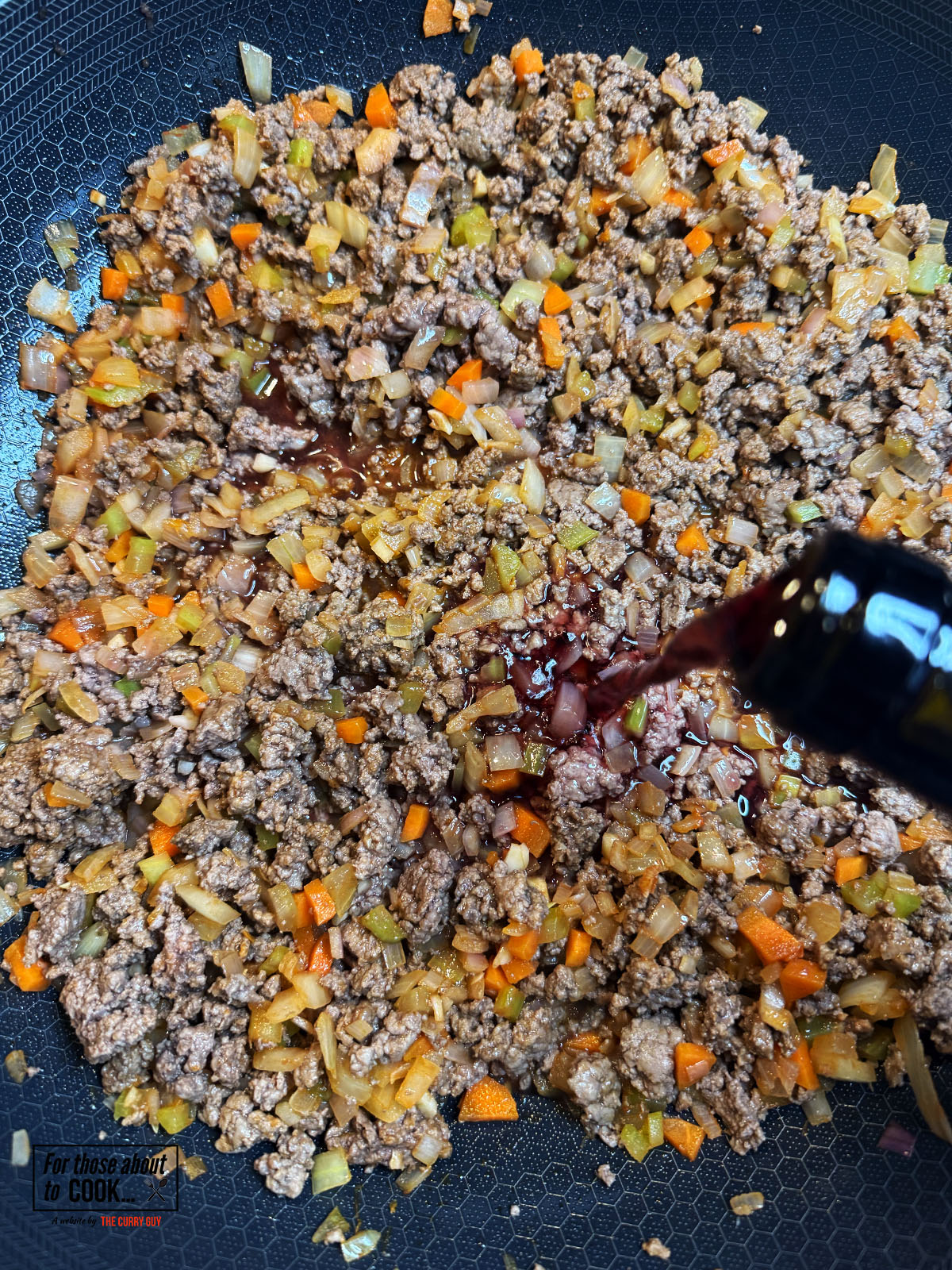 Beef added back to the pan and red wine added 