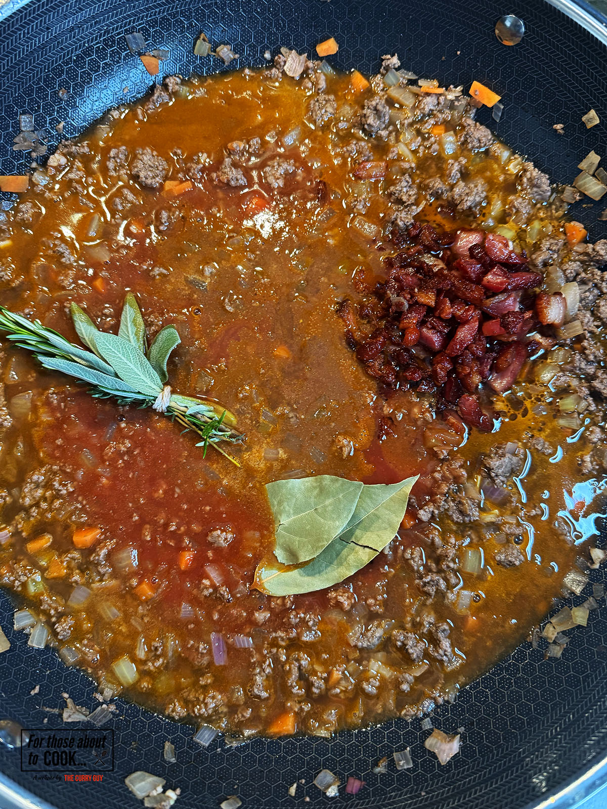 Bacon, fresh herbs and stock added to the pan to simmer