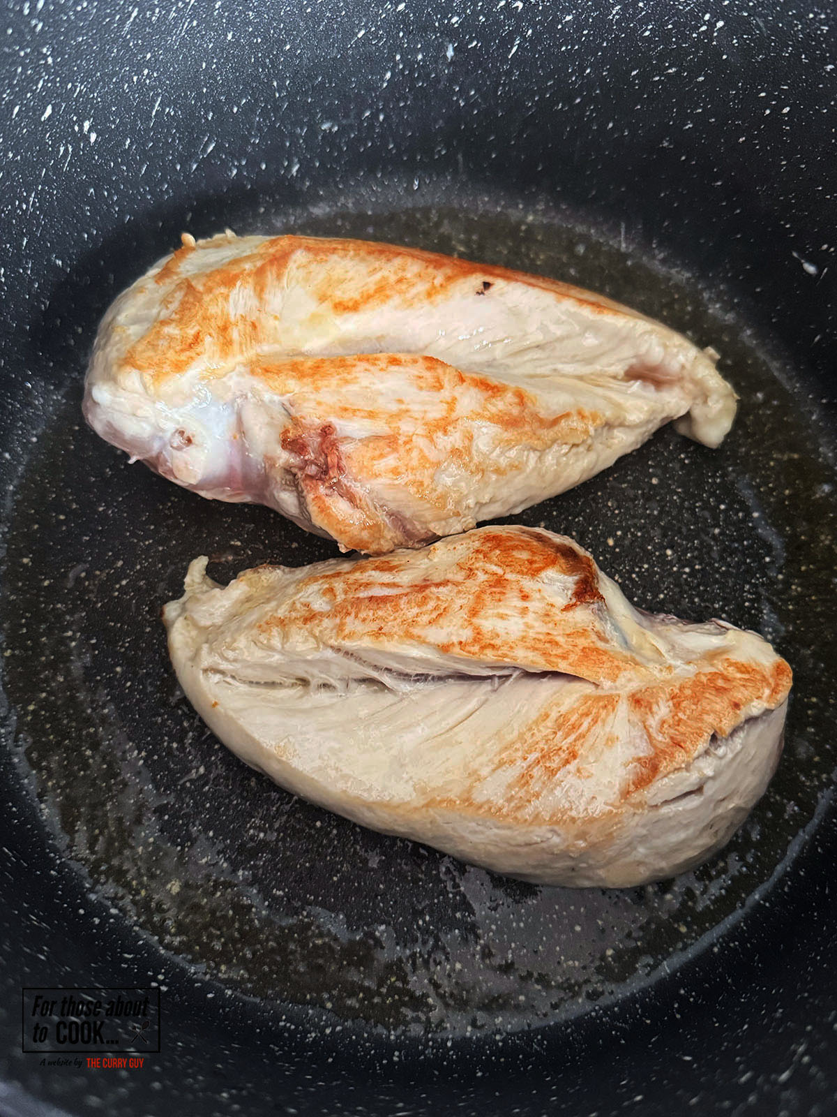Chicken breasts browning in a pan