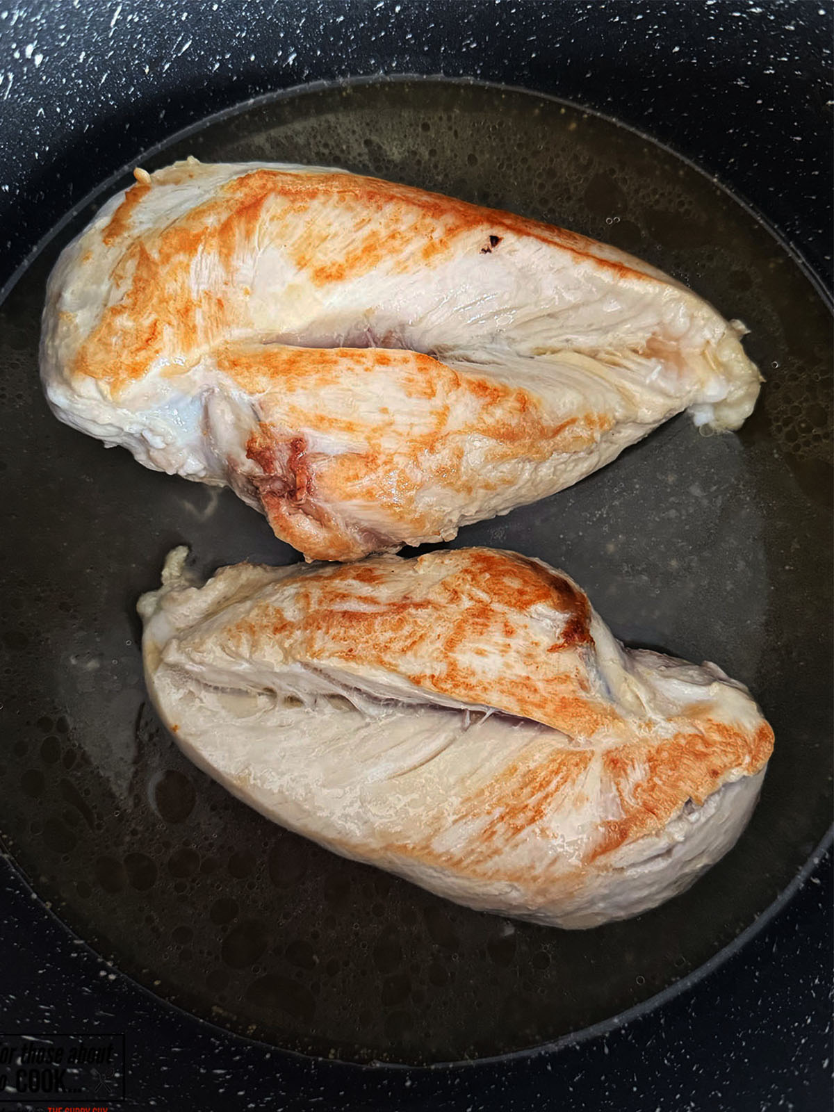 Chicken stock added to the pan and allowed to poach