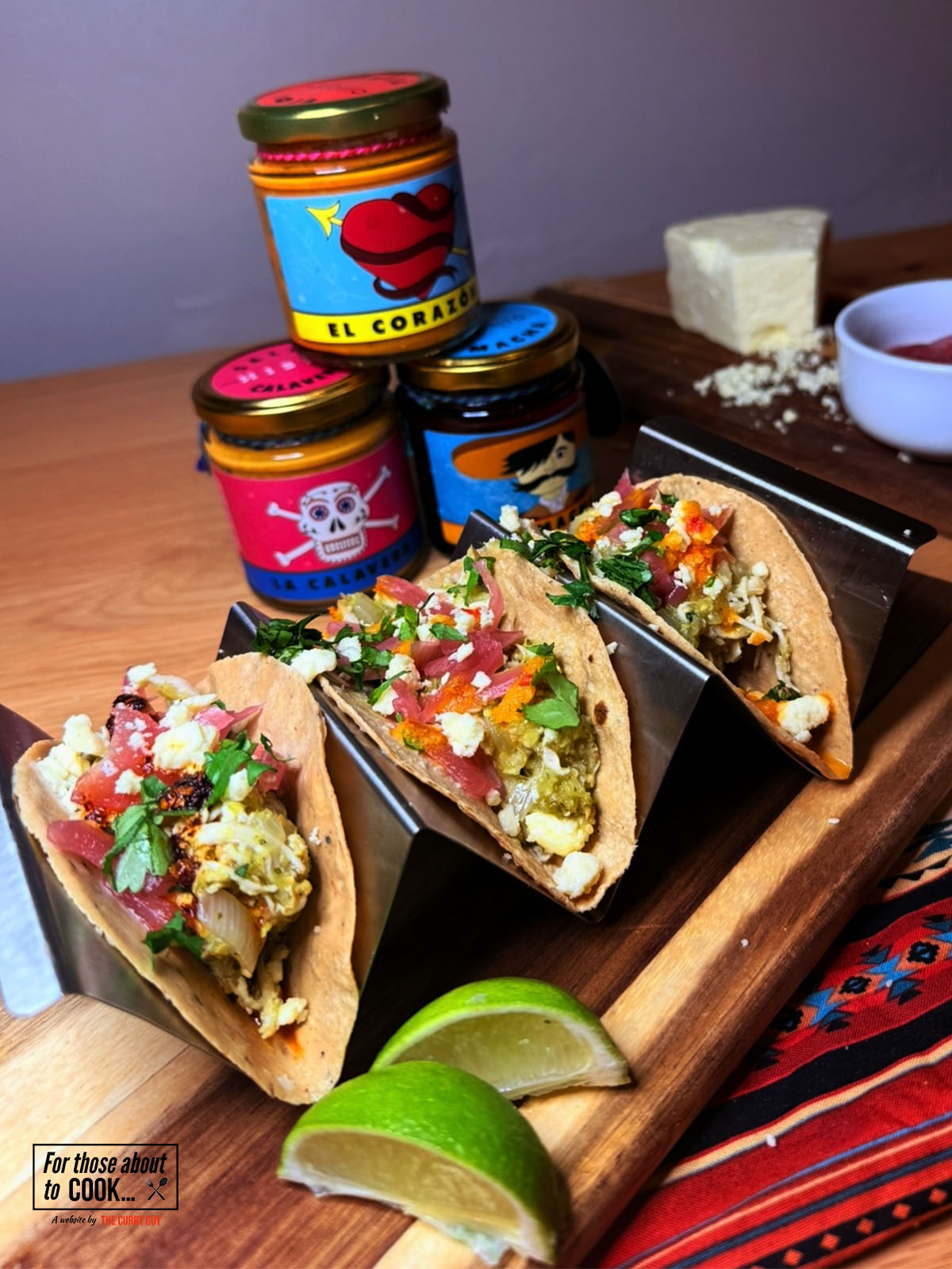 Salsa verde tacos topped with salsa and cheese