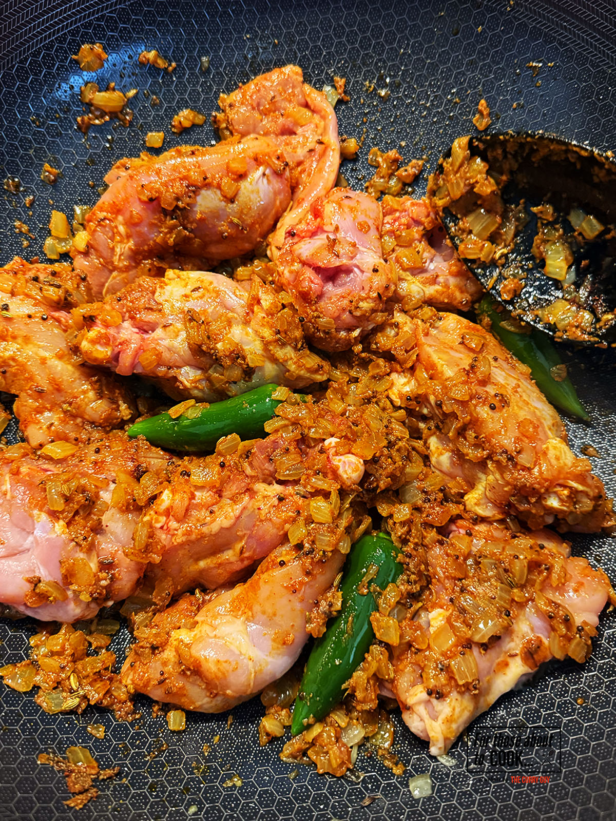Chicken added to the pan and coated in the spices