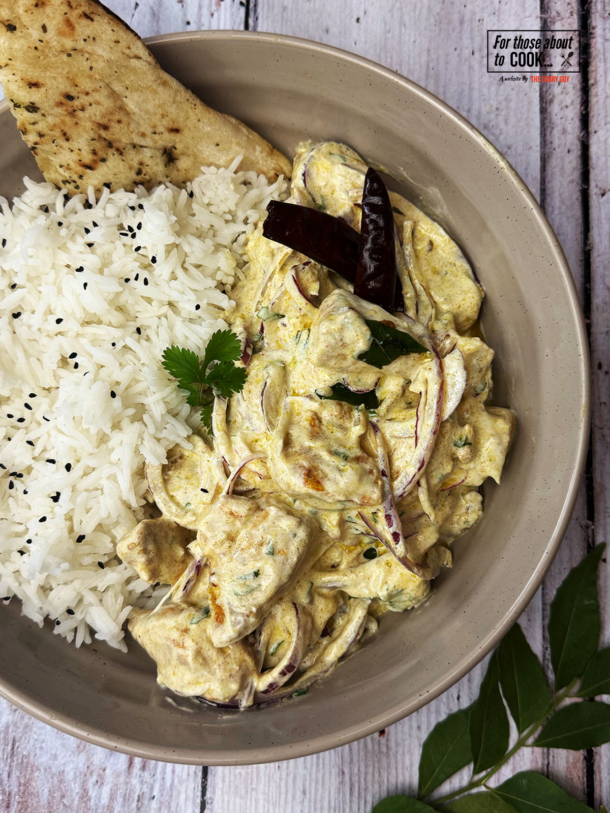 Chicken Chukauni served with rice and naan in a bowl