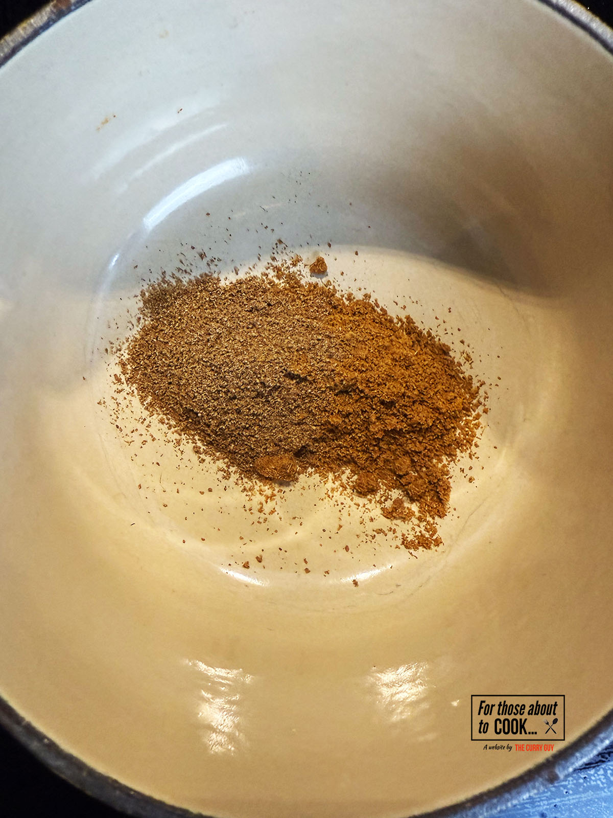 Ground cumin and coriander toasting in a pan