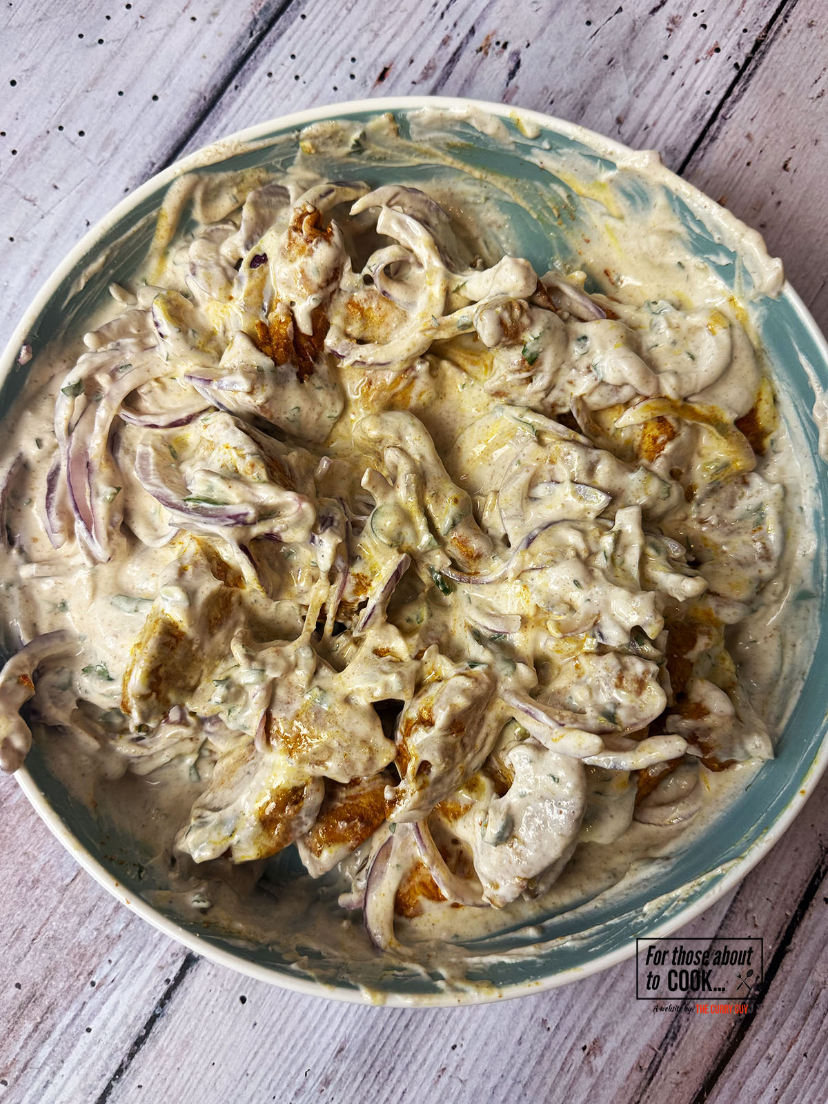 Cooled chicken and raw onion mixed in with yoghurt and spices