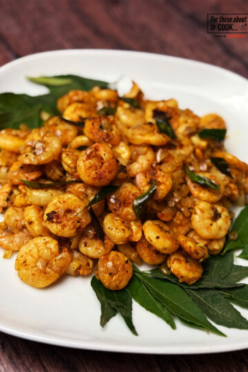 Kerala tawa prawns on a bed of curry leaves