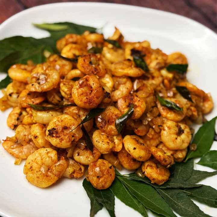 Kerala tawa prawns on a bed of curry leaves