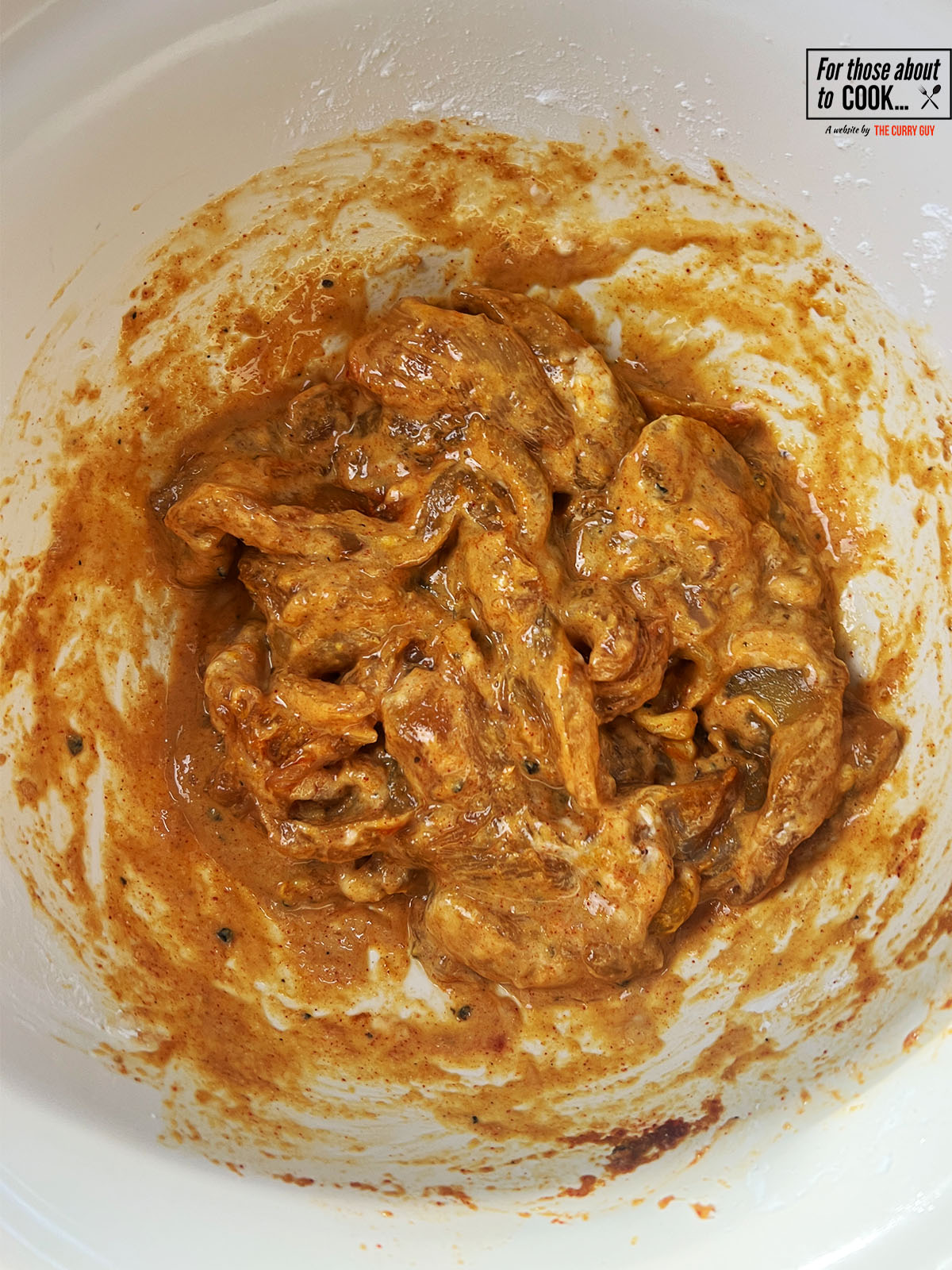 Marinade ingredients added to the bowl with the chicken 