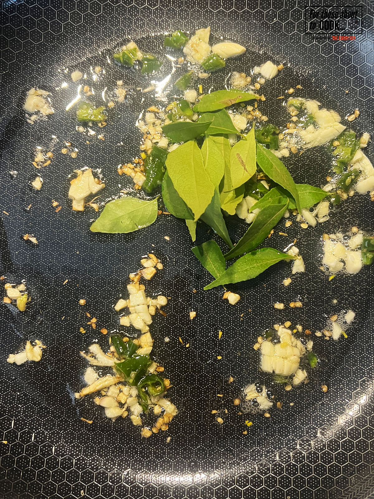 Garlic and curry leaves frying in the pan 