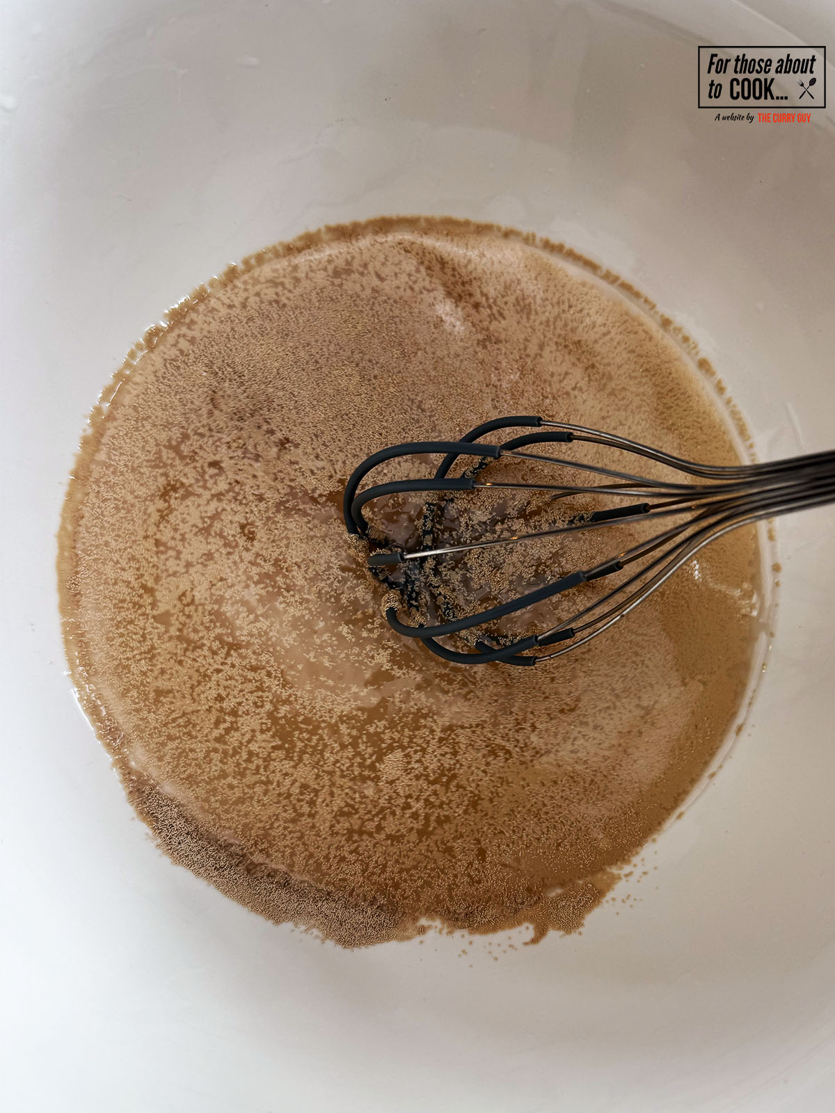 Yeast, sugar and warm water blooming in a bowl