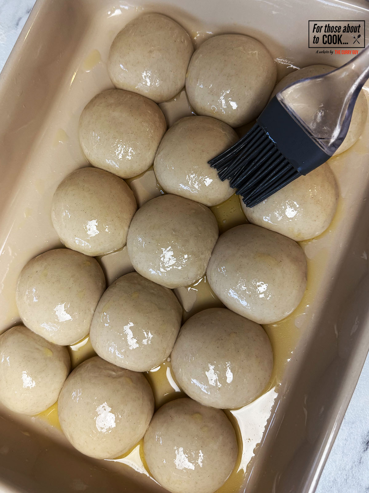 Risen dough balls brushed with butter