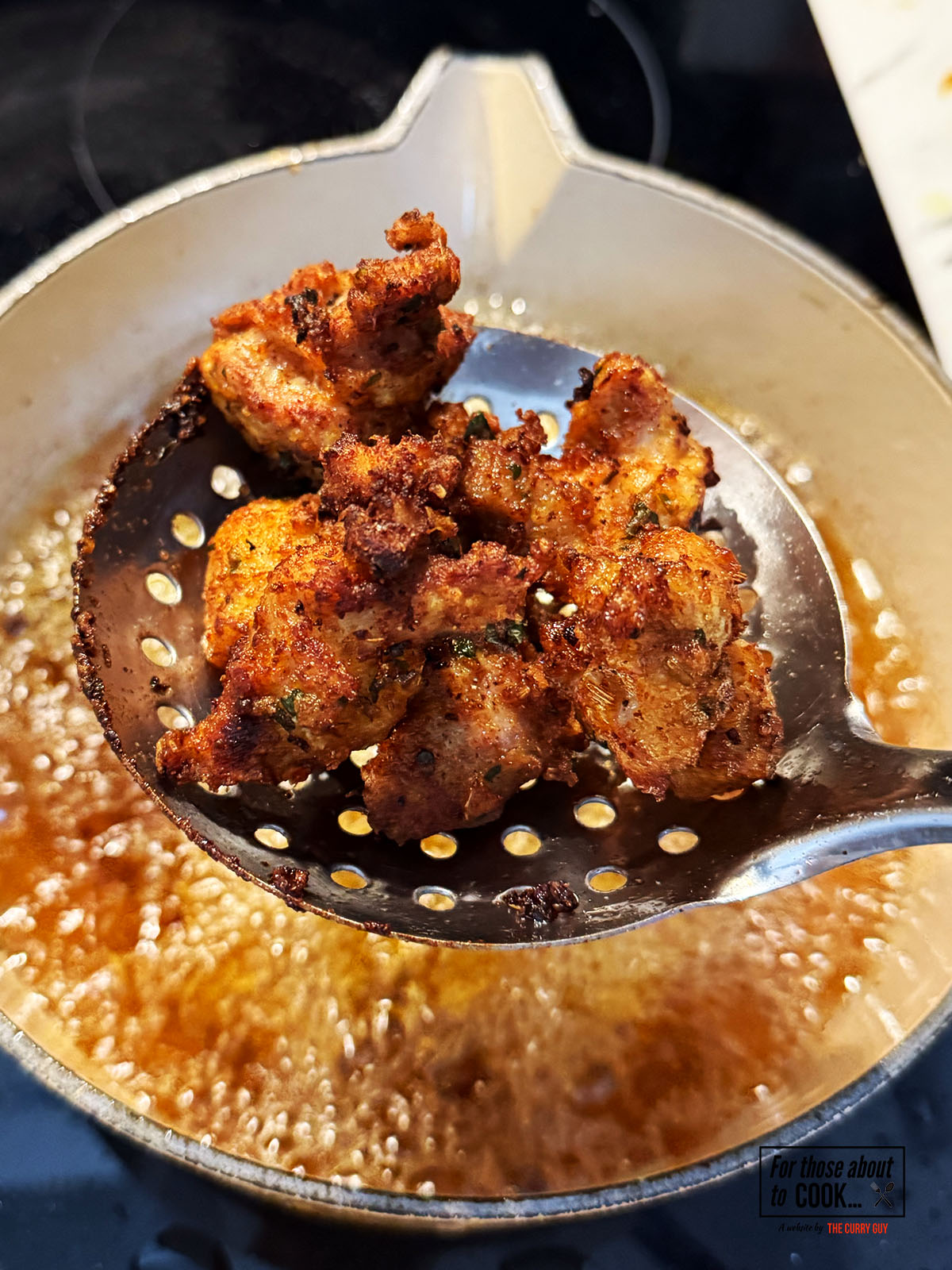Thigh pieces frying in the pan until golden brown