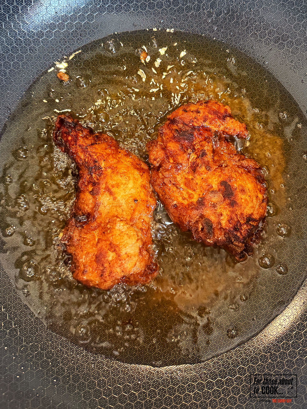 Chicken breast pieces frying in hot oil until golden brown