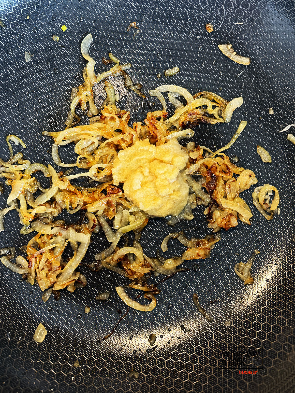 Garlic and ginger paste frying with onions in the pan