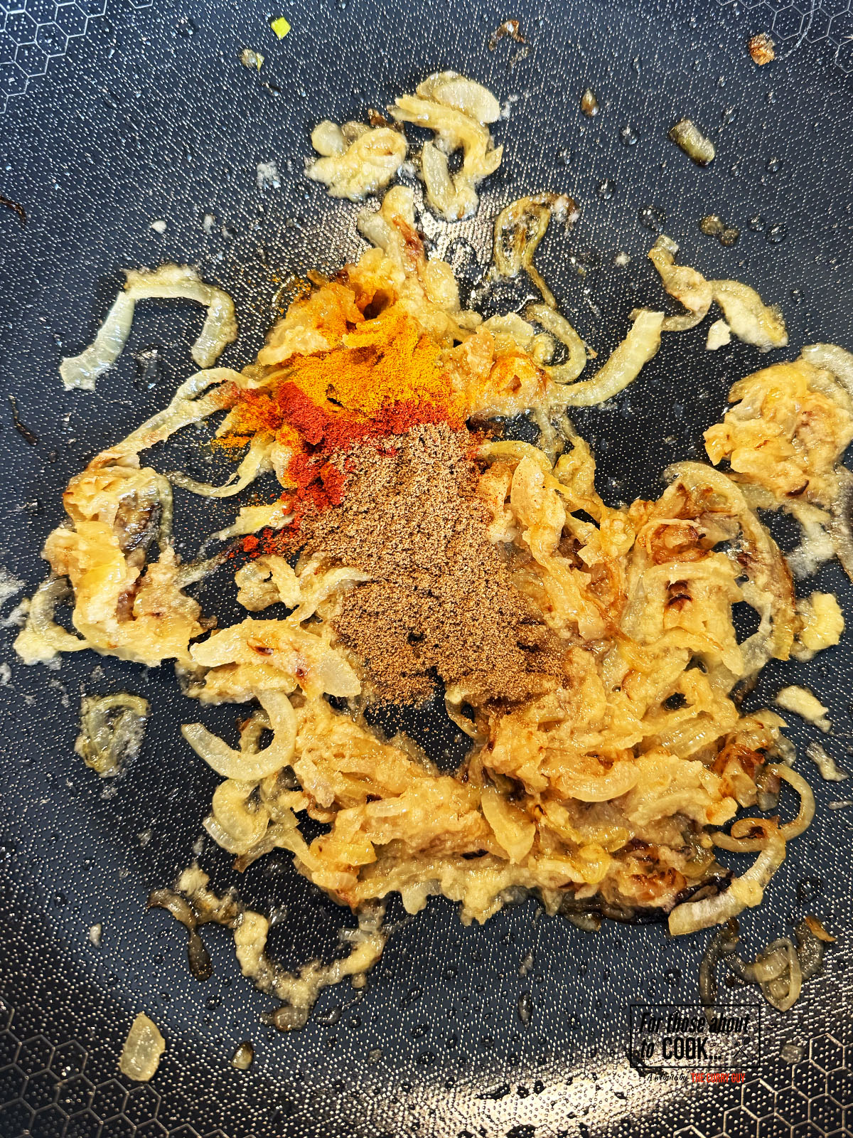 Ground spices added to garlic and ginger paste and onions