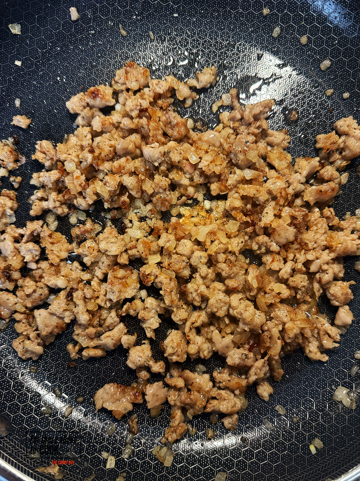 Sausage meat added to the pan and cooked until browned