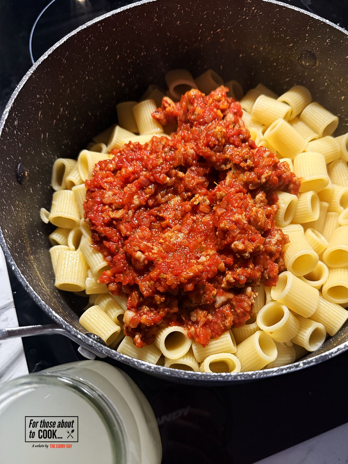 Passata sauce added to the drained pasta with cup of pasta water reserved 