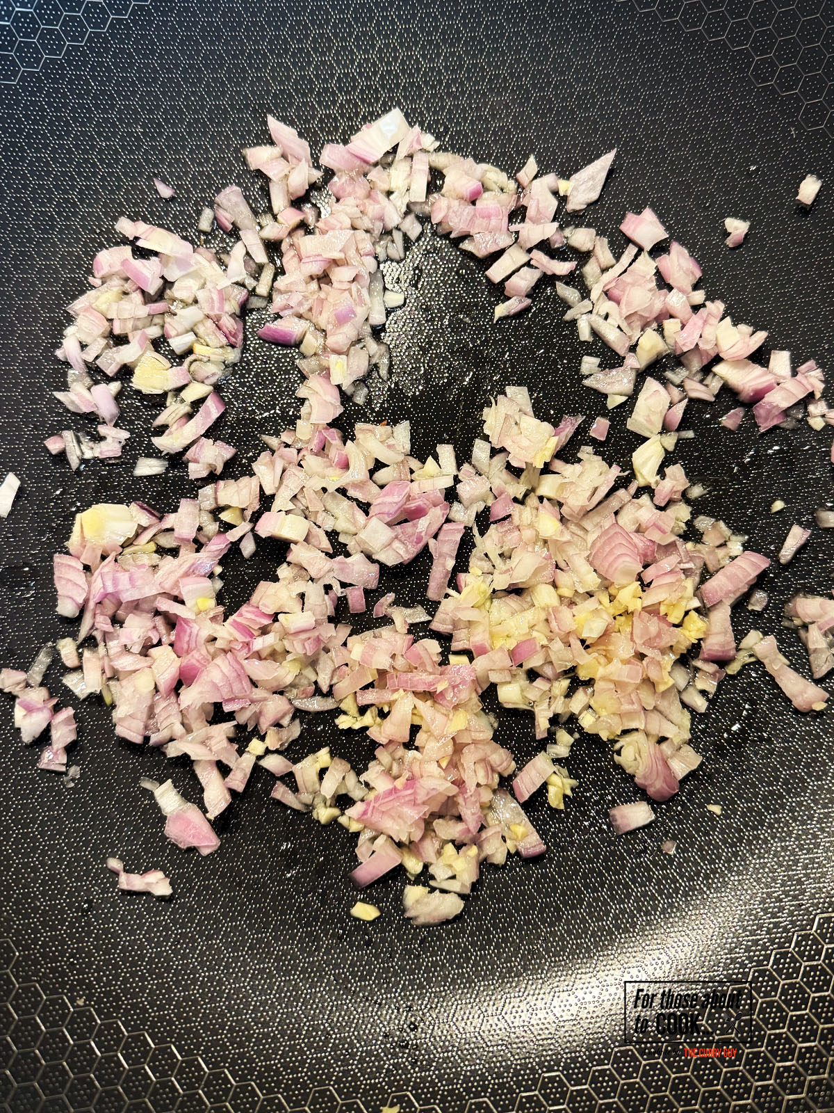 Shallots and garlic frying in a pan