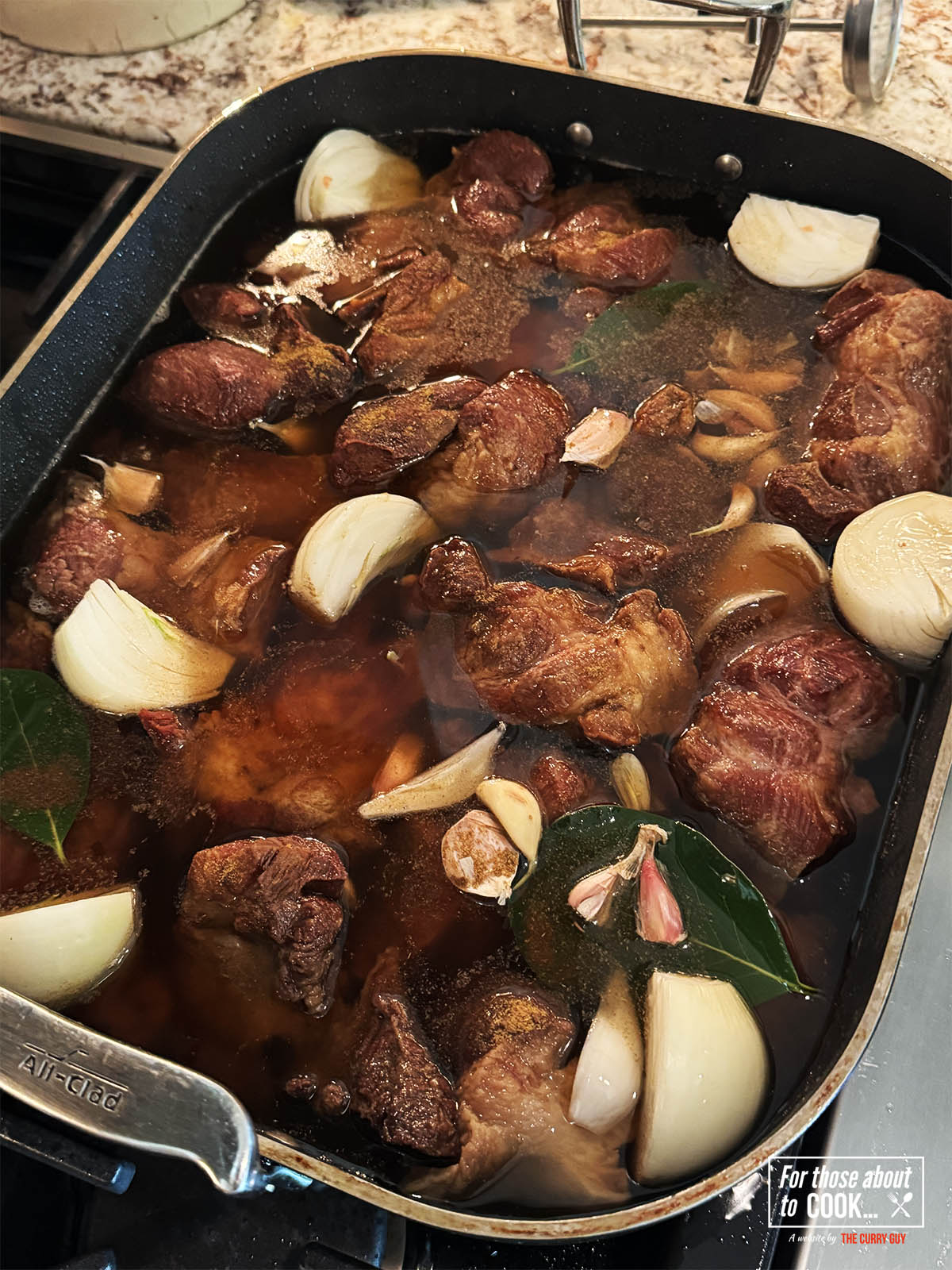 Stirring in the onion, garlic and herbs to the carnitas