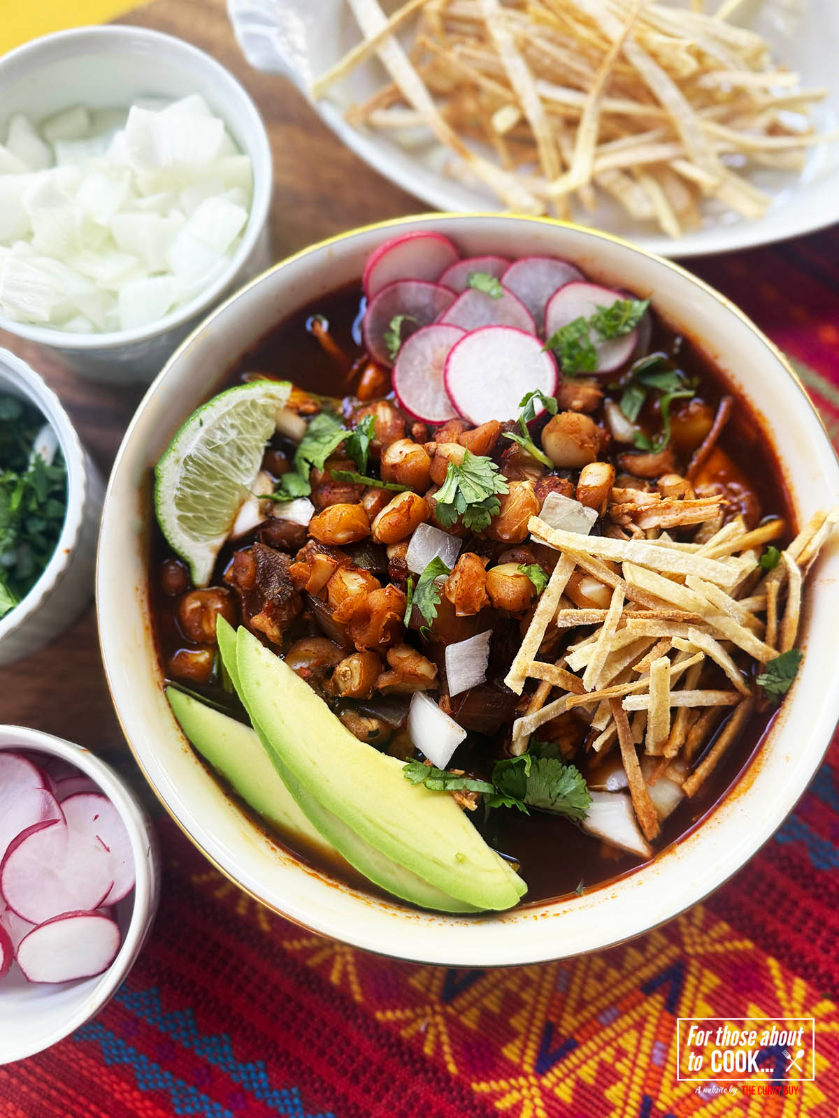 Pozole Rojo served up in a bowl with fresh toppings