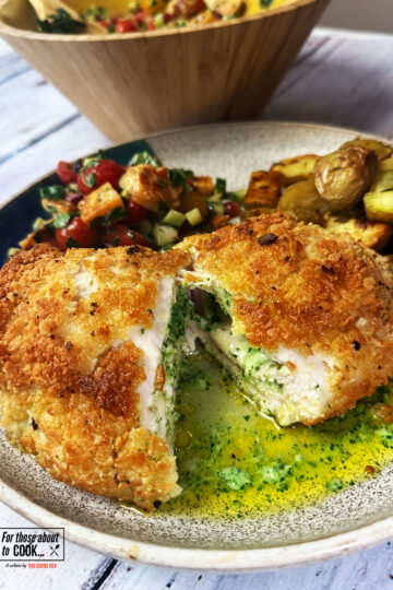 Chicken Kiev recipe plated up with garlic butter oozing out