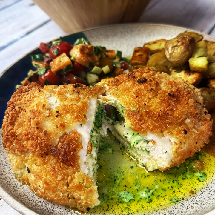 Chicken Kiev recipe plated up with garlic butter oozing out