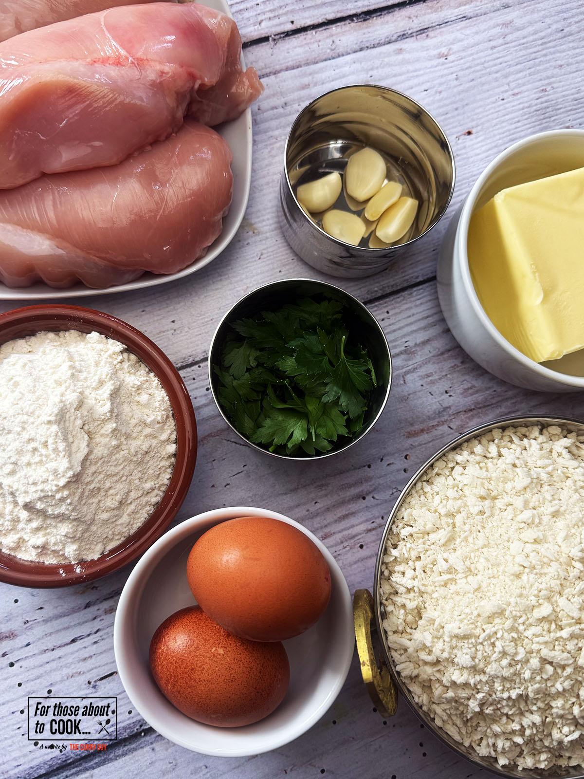 Ingredients for chicken kiev recipe laid out in bowls
