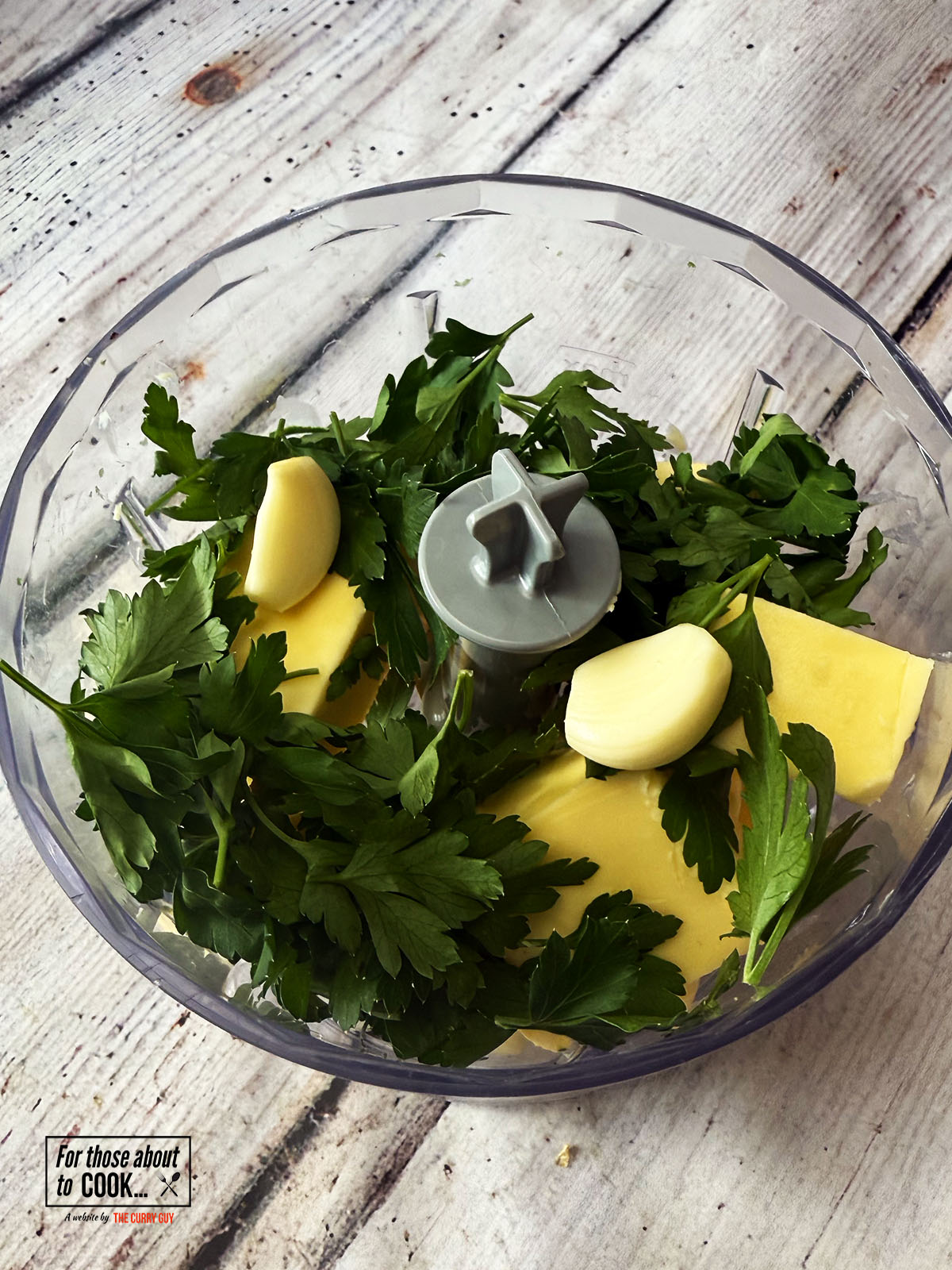 Ingredients for compound garlic butter in a food processor