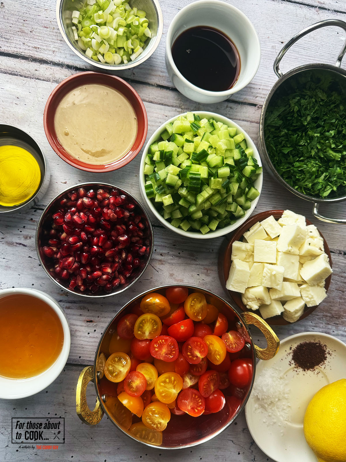 Ingredients for Halloumi salad separated into bowls 