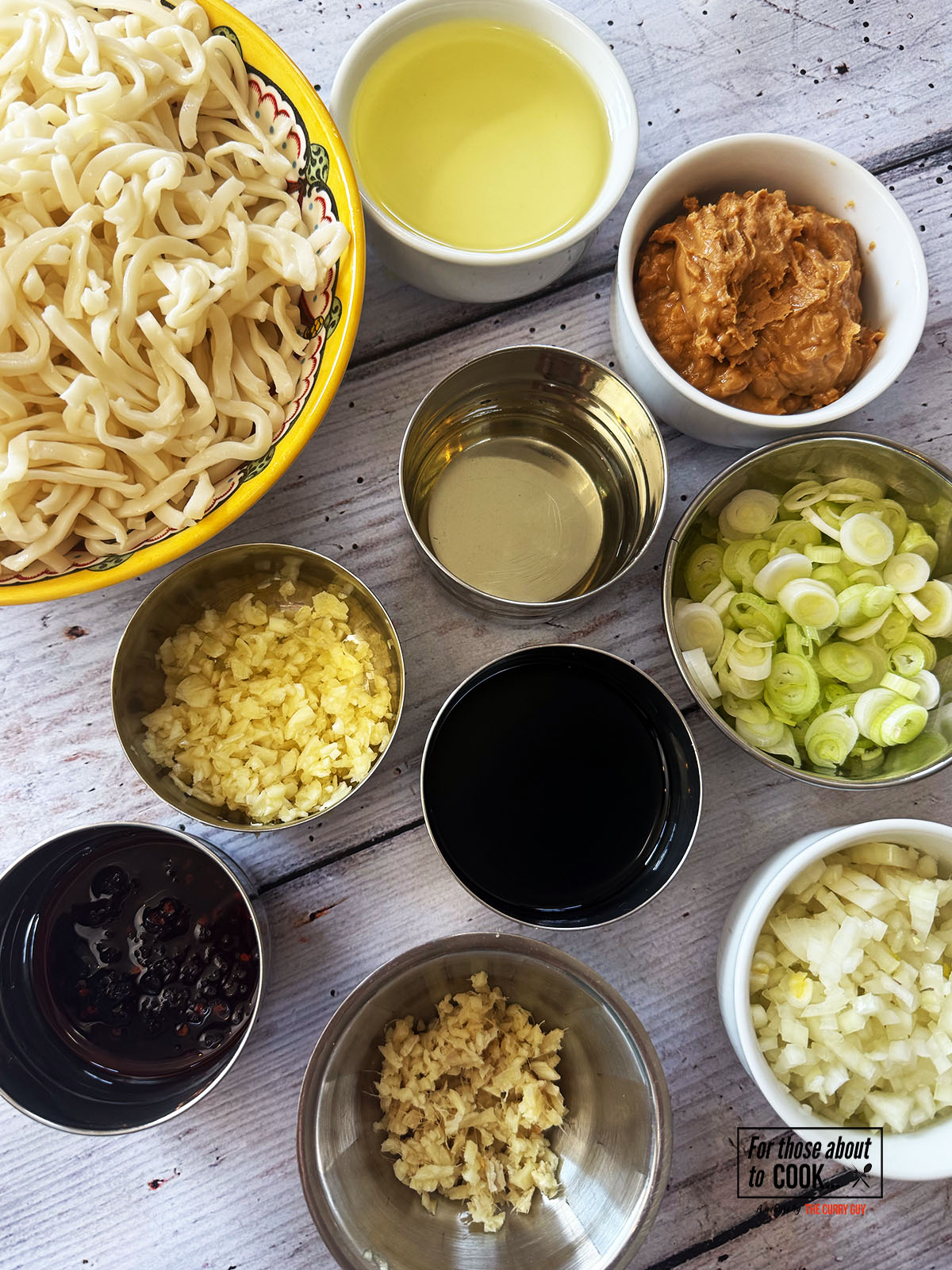 Ingredients for peanut butter noodles separated into bowls