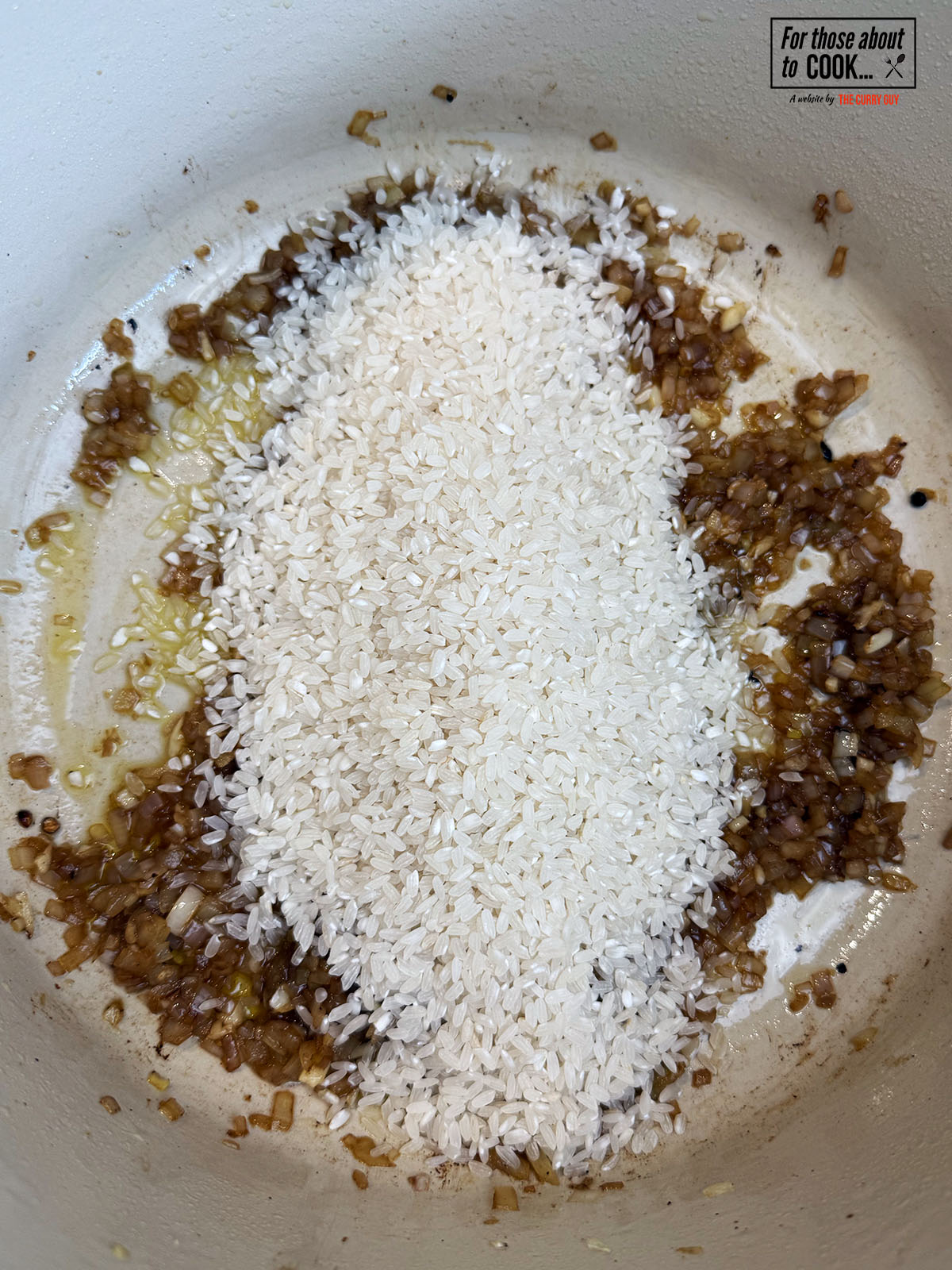 Arborio rice added to the pan to toast and crack