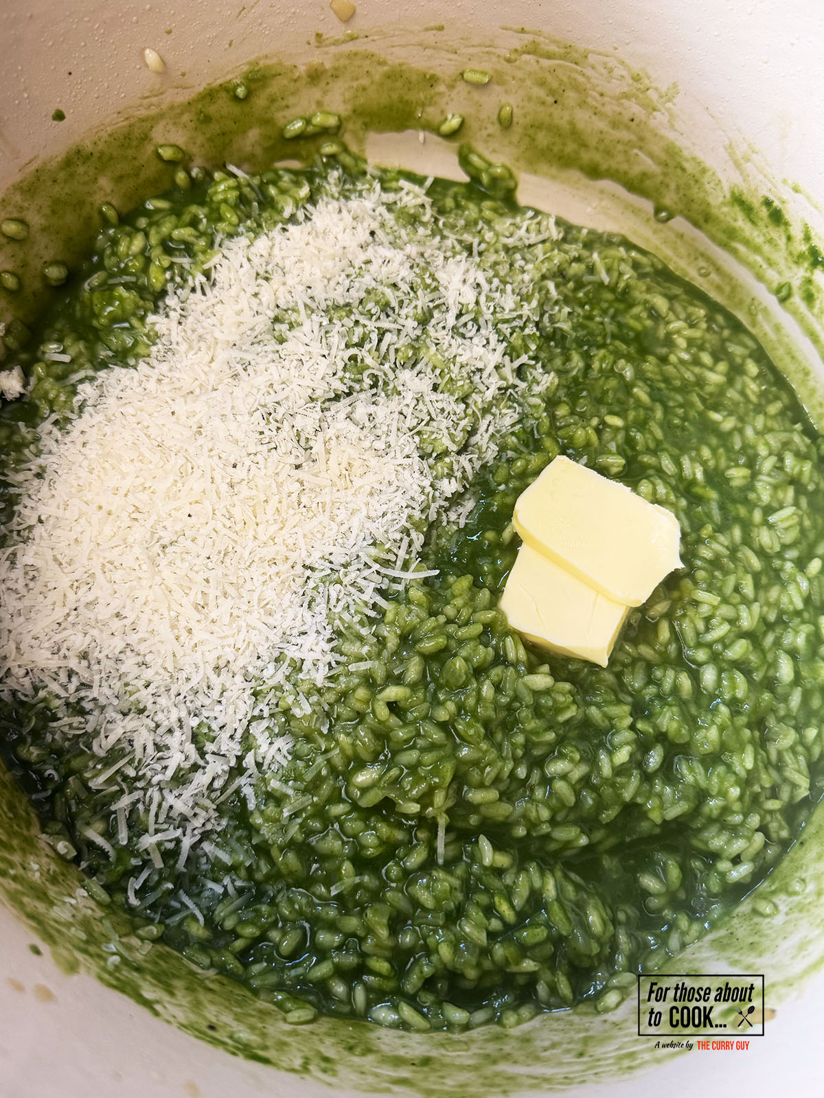 Green sauce added to the pot with the cooked risotto along with parmesan and butter
